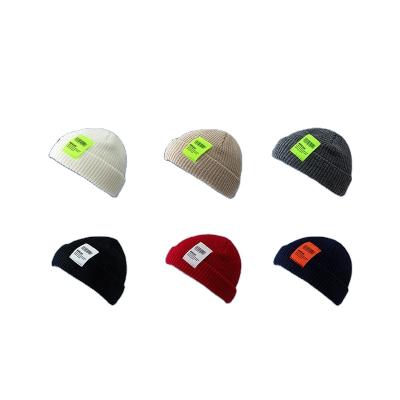 China 2021 COMMON New In The Common Wholesale Women's Acrylic Skully Skullies With Label Patch College Winter Hat Woven Skullies for sale