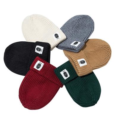 China COMMON 2021 Ready To Boat Dome Top Knitted Skull Beanies Wholesale Stripe Pattern Jacquard Thick Winter Hats Woven Label Dropship for sale