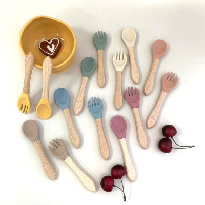 China Hot Selling BPA Free Baby Silicon Spoon Set With Wooden Handle for sale