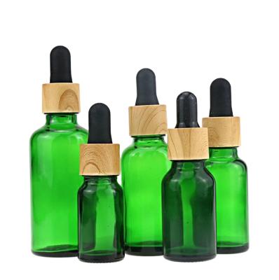 China Lead Free Amber Glass Essential Oil Bottle Glass Bottle With Bamboo Lid 10ml 15ml 30ml 50ml Dropper Bottle for sale