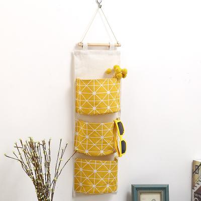 China Fold 3 Pockets Hanging Storage Bag Wall Mounted Cotton Canvas Organizer For Room for sale