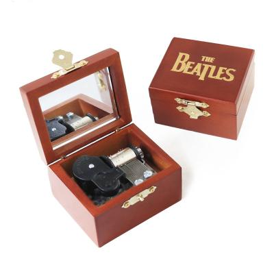 China Custom Designed Gift And Songs Roll Up Wooden Mini Music Box for sale