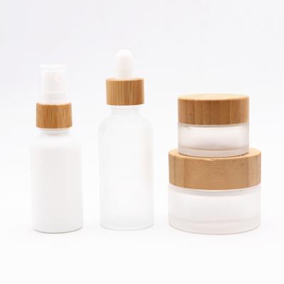 China 30ml CBD Hemp Oil 100ml Chemical Glass Bottle And Glass Jar With Bamboo Cap 50ml 100ml Essential Oil Bottle for sale