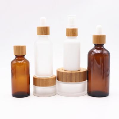 China 30ml CBD Hemp Oil Chemical Amber Glass Bottle And Glass Jar With Bamboo Cap 50ml 100ml Essential Oil Bottle for sale