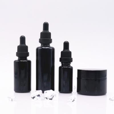 China Cosmetic Black Optical Dropper Bottles Glass 30ml 50ml Violet Essential Oil Bottle Serum Bottle With Dropper Cap for sale