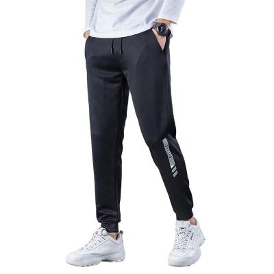 China Anti-Wrinkle Exercise Fitness Workout Strappy Slacks Light Up Men Joggers Sweatpants Breathable Elasticity Harem Running Pants for sale