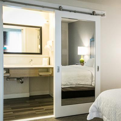 China Modern Hampton Inn White Primed Wood Frame Sliding Mirror Doors for sale