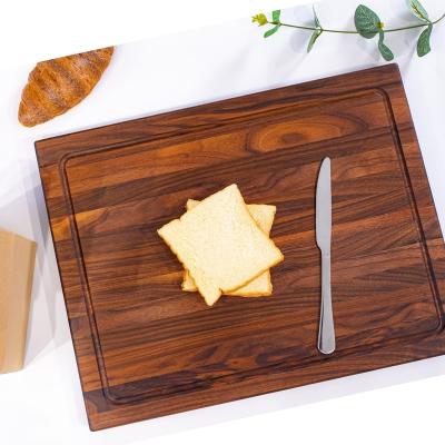 China Wooden chopping board stocked with black walnuts for sale