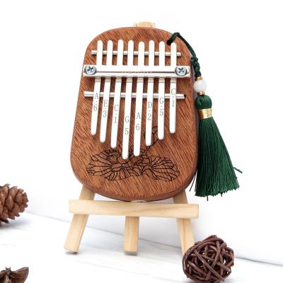 China Exquisite Accessories Mini Camphor 8keys Wooden Musical Instrument Kalimba For Kids Gift for sale