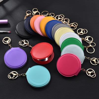 China Fashion Customized Logo Printing Makeup Mini Mirror PU Round Magnifying Mirror Small With Key Chain Fold Double Side Mirror Pendant for sale