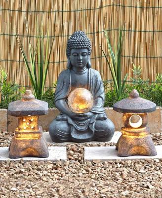 China Europe Customized Decorative Resin Buddha Statue Pagoda Sitting Lantern With Solar Garden Light Collection for sale