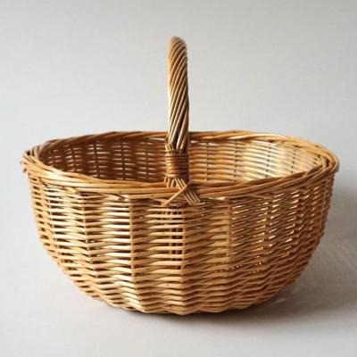 China China Handwoven Curve Handle Pole Wicker Basket Willow Basket Round Wicker Storage Customized for sale