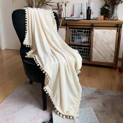 China PORTABLE Custom Super Soft Solid Color Polyester Flannel Fleece Pompom Fringe Sofa Blanket for sale