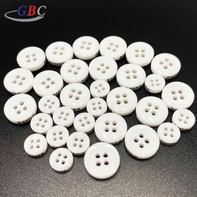 China New Design Custom White Plastic Resin Button Washable For Clothes for sale