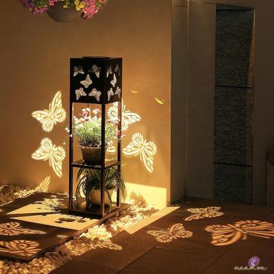 China Multilayer Garden Metal Planter Stand with Solar LED Pattern Light for Outdoor Garden for sale