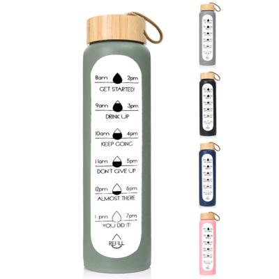 China Factory Large Capacity 1000ml Sports Drink Bottles Custom Viable Bamboo Sleeve Silicone Lid Glass Water Bottle With Time Marker for sale