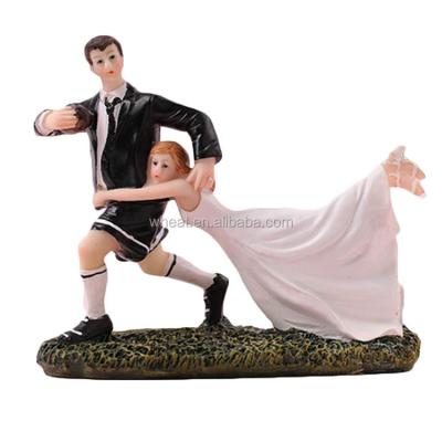 China Marry Couples Rugby Figurine Funny Resin Wedding Cake Topper for sale