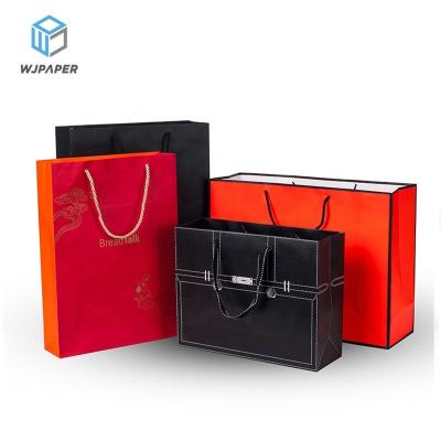 China Custom printed matte luxury retail retail shopping bags disposable private label black clothing store kraft paper art paper bags with logos for sale