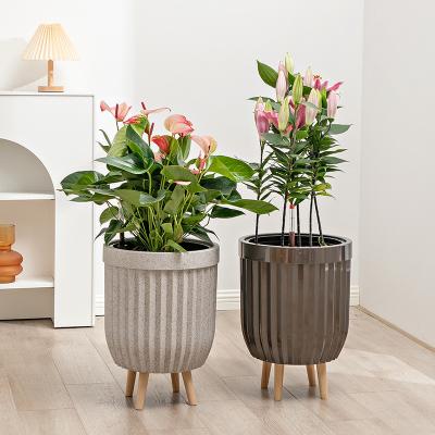 China Contemporary Sandblasted Self Watering Plastic Flower Pot With Wooden Feet for sale