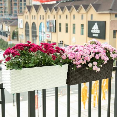 China Contemporary Rattan Outdoor Plastic Flower Pots With Irrigation System Wall Hanging Plant Colorful Plastic Pots For Garden for sale