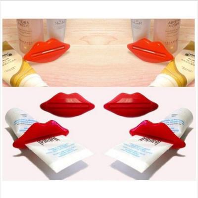 China Viable Cute Red Lip Rolling Home Bathroom Squeezer Easy Toothpaste Dispenser for sale