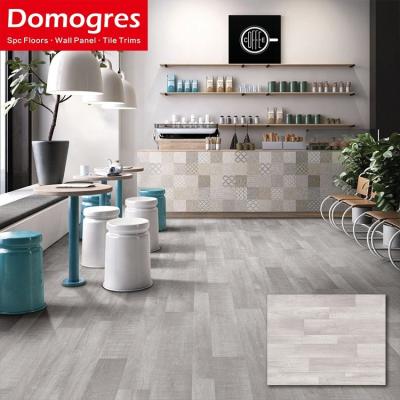 China Waterproof/Anti-Slip/Wear Resistant/Fire Retardant/Sound Barrier Cheap Prices Gray Hybrid Wooden Grain Embossed Surface Stone Waterproof Spc Vinyl Flooring Planks Click for sale