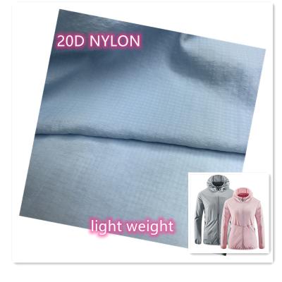 China Cheap stretch price 0.25cm plaid 20D ripstop nylon waterproof fabric for coat and skin sportswear for sale