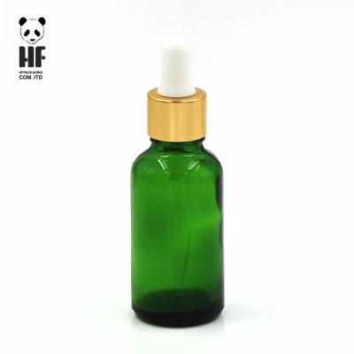 China Empty Dark Green Personal Care 50ml Boston Round Essential Oil Glass Bottle With Pipette for sale