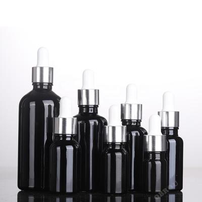 China Cosmetic 1 oz hair oil glass bottle with glossy black non-transparent eye dropper dropper glass bottle 100ml for sale