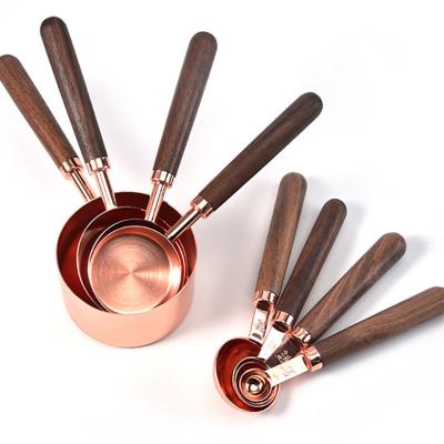 China Viable Popular Amazon Rose Gold Acacia Wood Handle Stainless Steel Measuring Cup Set 8 Pieces With Measuring Cup for sale