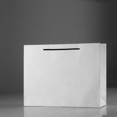 China Recycled Materials Brand Boutique White Paper Shopping Carry Bag With Logo Retail Paper Bag Customized for sale