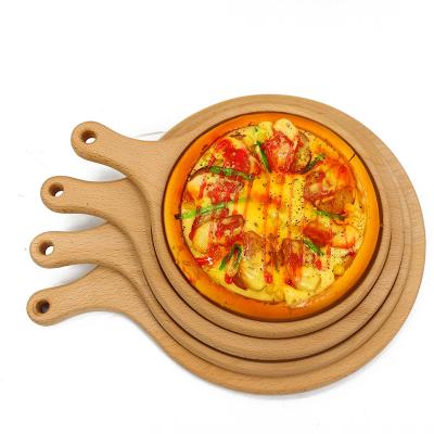 China Disposable Round Acacia Cutting Board Shovel Skin Wood Dish With Groove Wooden Pizza Serving Tray for sale