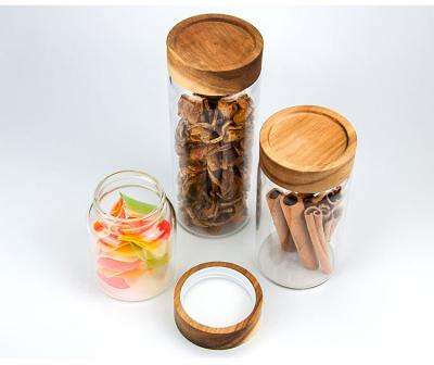 China 180ML 300ML 400ML Kitchen Food Viable Clear Airtight Cylinder Storage Glass Candy Jar With Acacia Wood Lid for sale