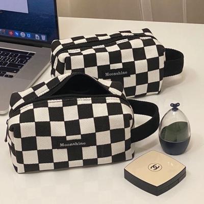 China Eco-Friendly Portable Black And White Cosmetic Bag Eco-friendly Checkerboard Lattice Ins Storage Bag Classic Toiletry Bag for sale