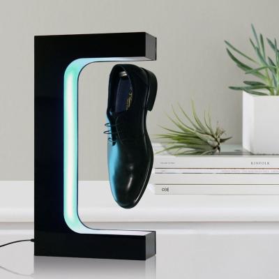 China Designer Premium Quality Creative Durable Rotating Magnetic Levitation Floor Display Advertising Shoes Stand for sale