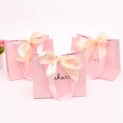 China Custom size recyclable gold logo bowknot jewelry hot stamping luxury paper bag with satin bow handle for sale