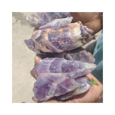 China Natural Africa Wolf Teeth Shape Amethyst Raw Crystal Gravel Tumbled Stone For Decoration for sale