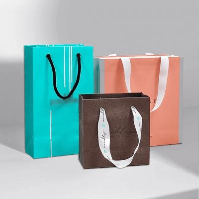 China Ribbon Accessories Custom Logo Paper Handbag for Retail Shopping Gift Packaging Bags for sale