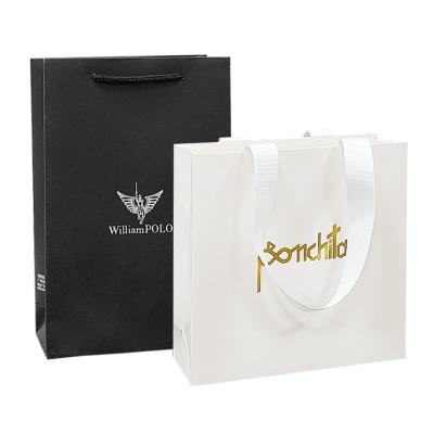 China Recycled Luxury Paper Shopping Bags Clothing Retail Paper Bags With Handles for sale