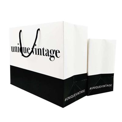 China Custom Logo Clothing Shopping Gift Packaging Paper Bag with Drawstring and UV Coating for sale