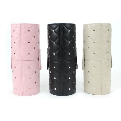 China Hot Selling Large Capacity Pink Rivet Style Makeup Brush Holder Case Portable Travel PU Leather Cosmetic Cylinder for sale