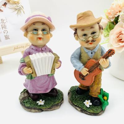 China Creative Europe Resin Crafts Toys Musical Instrument Old Man Elder Couples Furnishing Articles Wedding Gift for sale