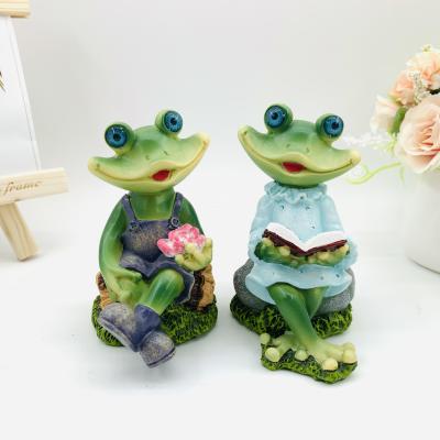 China China Resin Frog Garden Ornaments Leisure Reading Frog Couple Resin Open Ornaments Home Gifts for sale