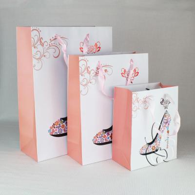 China Recyclable Luxury Pink Paper Gift Bag For Shopping With Ribbon Handle for sale