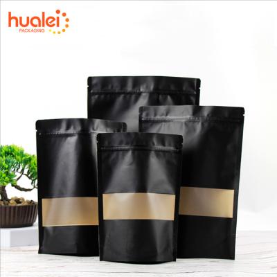 China Factory wholesale 100pcs/pack food packaging recyclable stand up pouch black kraft paper bag with clear window coffee tea snack for sale