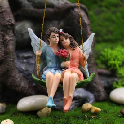 China New Dropshipping Europe Resin Boy And Girl Sitting On The Swing Home Decorative Statue Fairy Garden Figurines Miniature for sale