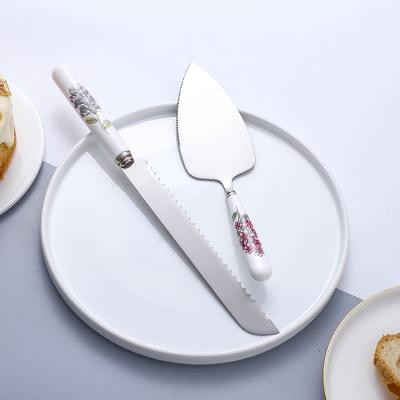 China New Design Sustainable Silver Flower Mirror Flower Stainless Steel Handle Wedding Cake Knife Server Ceramic Server Set Polish for sale