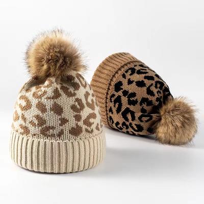 China Fashion JOINT Classic Custom Leopard Grain Fur Pompom Ball Knitted Hat Winter Warm Add Wool Beanie Hats For Women for sale