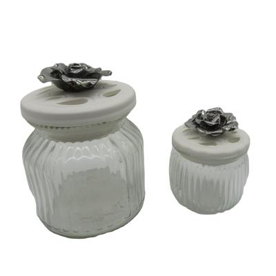 China The Freshness Preservation Glass Storage Jar with Handcraft Ceramic Flower Ceramic Cookie Jar for Home Decoration for sale