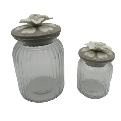 China The Freshness Preservation Glass Storage Jar with Handcraft Ceramic Flower Glass Cookie Jar for Home Decoration for sale